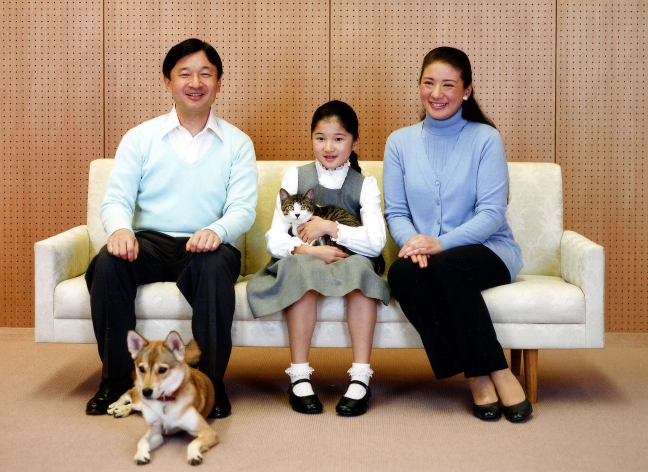 Naruhito, Aiko and Masako pose with their pets in December 2010.