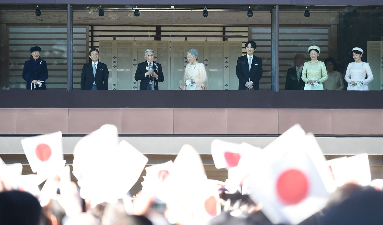 Naruhito, second from left, joins his father as they greet the public at the Imperial Palace in Tokyo in December 2014.
