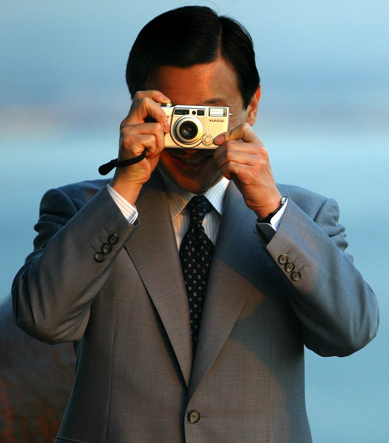 Naruhito takes a photo of photographers during a five-day visit to Portugal in May 2004.