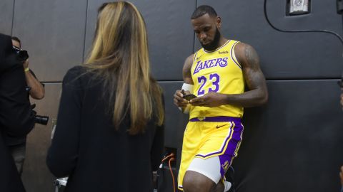 LA Lakers' LeBron James checks his cellphone ahead of a press conference