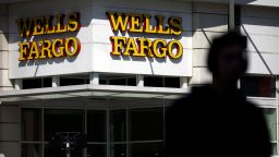 Signage is displayed outside a Wells Fargo & Co. bank branch in Los Angeles, California, U.S., on Thursday, April 19, 2018. Wells Fargo & Co.'s financial ties to gunmakers and the National Rifle Association have prompted the American Federation of Teachers to remove the bank from its list of recommended mortgage lenders. Photographer: Patrick T. Fallon/Bloomberg via Getty Images