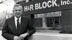 Henry Bloch stands in front of one of H&R Blocks' 12,000 stores.