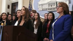 Olympic Gold Medalist Aly Raisman, foreground left, joined by dozens of victims of sexual assault by USC's Dr. George Tyndall, speaks in support of a measure by Assemblywoman Eloise Gomez Reyes, D-,San Bernardino, right, that would extend the statute of limitations to file civil lawsuits against Tyndall, at the Capitol Tuesday, April 23, 2019, in Sacramento, Calif. Tyndall, who was an OB GYN at the USC health center, is accused of sexually assaulting and abusing women under his care for nearly three decades. Raisman was assaulted by former USA Gymnastics doctor Larry Nassar. (AP Photo/Rich Pedroncelli)