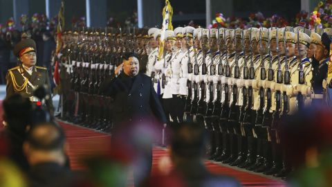 In this photo provided by the North Korean government, North Korean leader Kim Jong Un inspects an honor guard at an undisclosed train station in North Korea on Wednesday before leaving for Russia.