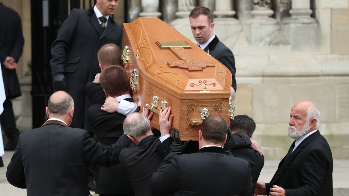 McKee's coffin is carried into the funeral service.