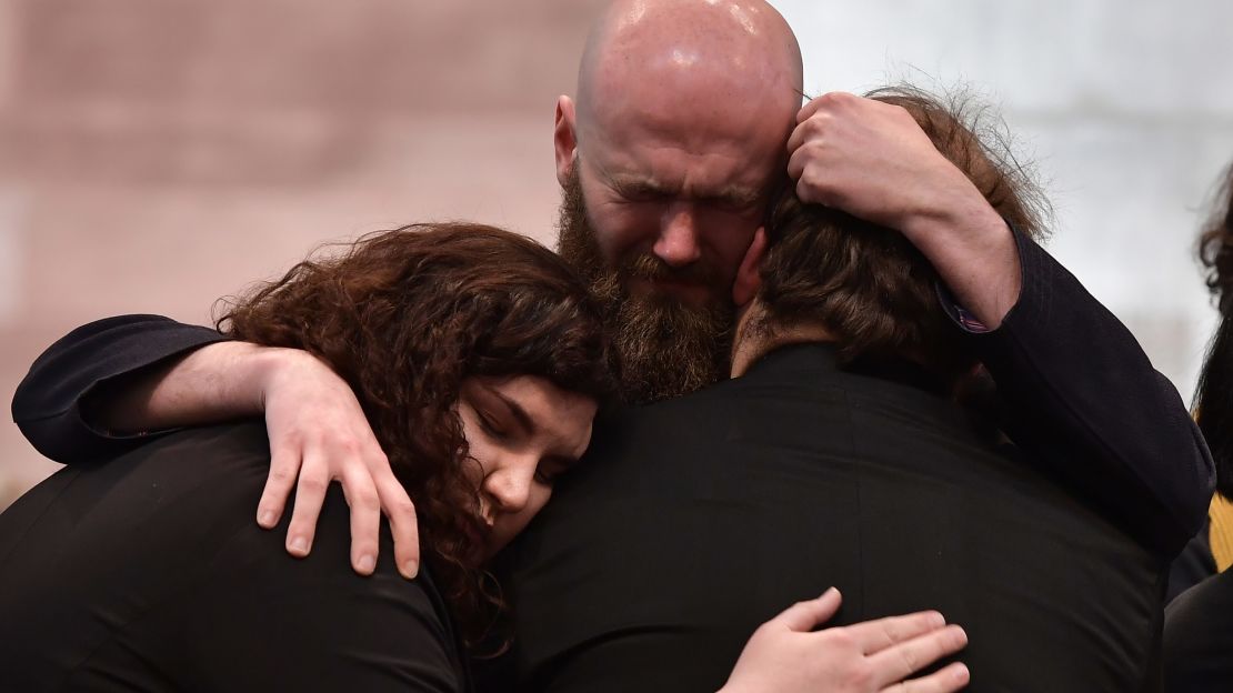 Mourners embrace during the service for killed journalist Lyra McKee.