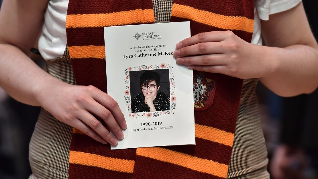 A mourner wearing a Hogwarts scarf holds the order of service for Lyra McKee.