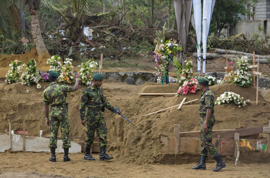 Members of a security task force search for explosives ahead of victims' mass burials in Negombo on Wednesday.