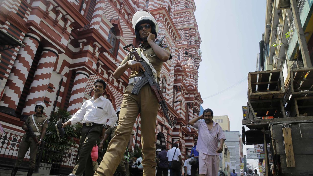 A Sri Lankan police officer patrols out side a mosque in Colombo, Sri Lanka.