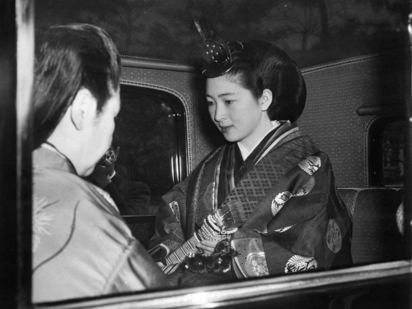 The future empress, seen in traditional ceremonial robes, is photographed on her way to the Kashiko-dokoro, or the Imperial Palace sanctuary, on her wedding day in 1959.