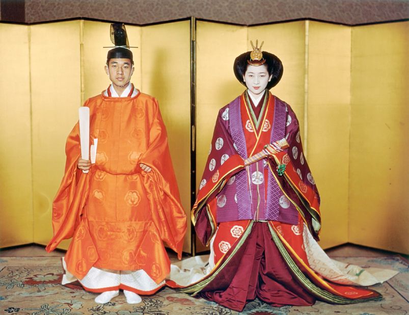 The couple pose during their wedding at the Imperial Palace in Tokyo. Michiko wore an elaborate "junihitoe," a 12-layered kimono with symbolic patterns. 