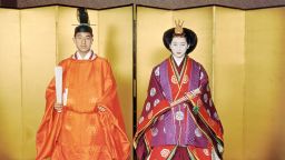 This April 10, 1959 picture shows Japan's Emperor Akihito (L) and Empress Michiko (R) posing for their wedding at the Kashiko Dokoro in Imperial Palace in Tokyo.