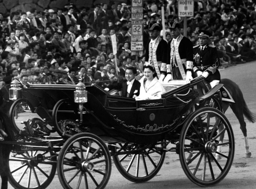 The newly-wed Akihito and Michiko ride in a royal carriage through the streets of Tokyo on their wedding day. Shigeo Suzuki, a former TV producer who oversaw coverage of the 1959 ceremony, recalls filming the couple waving happily to the crowds. "Their smiles," he recalled, "seemed as if they too were feeling the beginning of a new era."