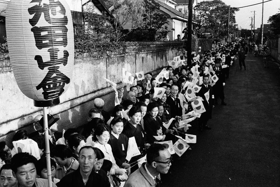 Tokyo residents pictured in front of Michiko Shoda house before her wedding to Akihito in 1959. The public was fascinated with the soon-to-be princess. 