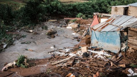 People abandon their homes after they were destroyed by torrential rains and flash floods
at an informal settlement of BottleBrush, south of Durban, on April 23. 