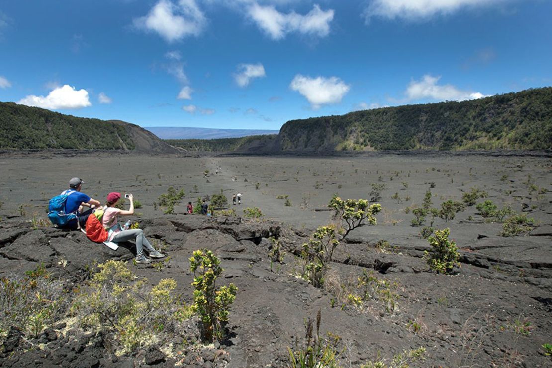 Park visitors stop for a rest and a photo on Kīlauea Iki Trail.