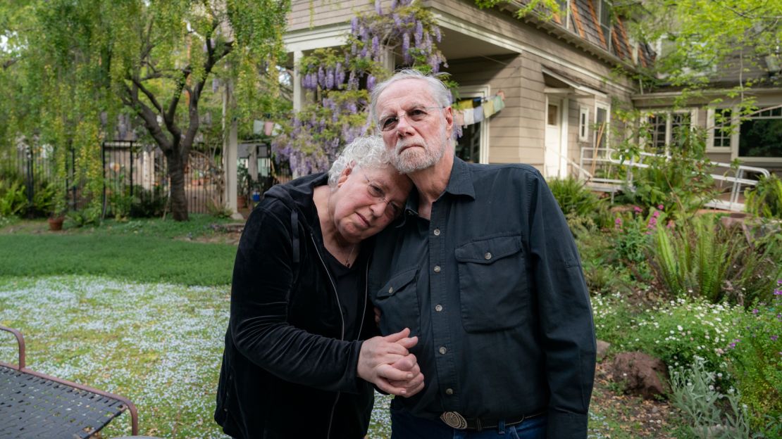 Davis and Dafoe in front of their Palo Alto home. "He's saving lives," Dafoe says. "Just by lying there."