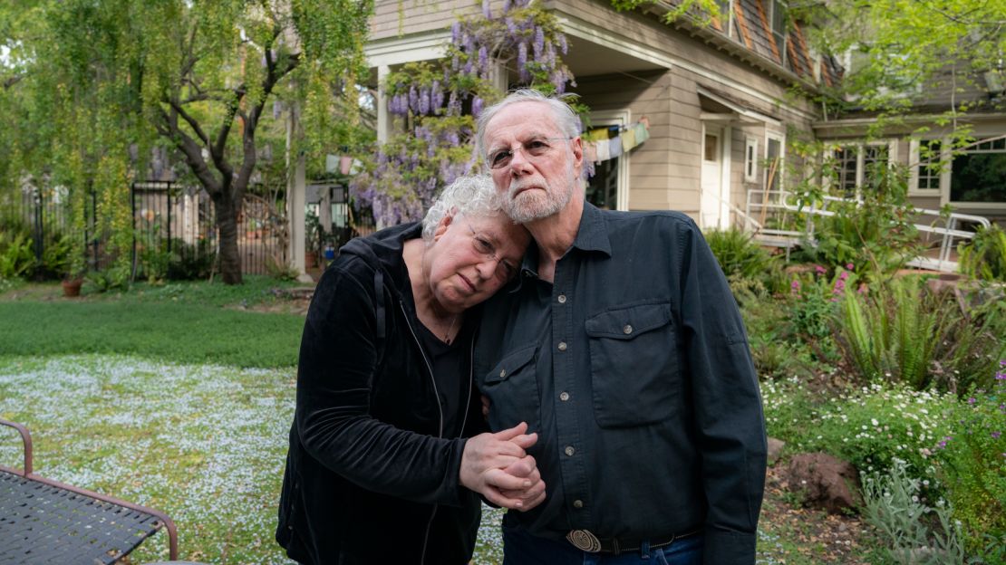 Davis and Dafoe in front of their Palo Alto home. "He's saving lives," Dafoe says. "Just by lying there." 