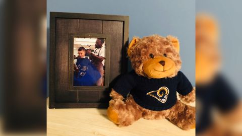 Connor keeps this framed photo of him reading with barber Jerry Jones.