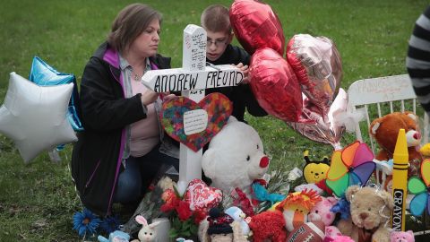 Angela Krambeer and her son Dylan visit a memorial outside AJ's home. 
