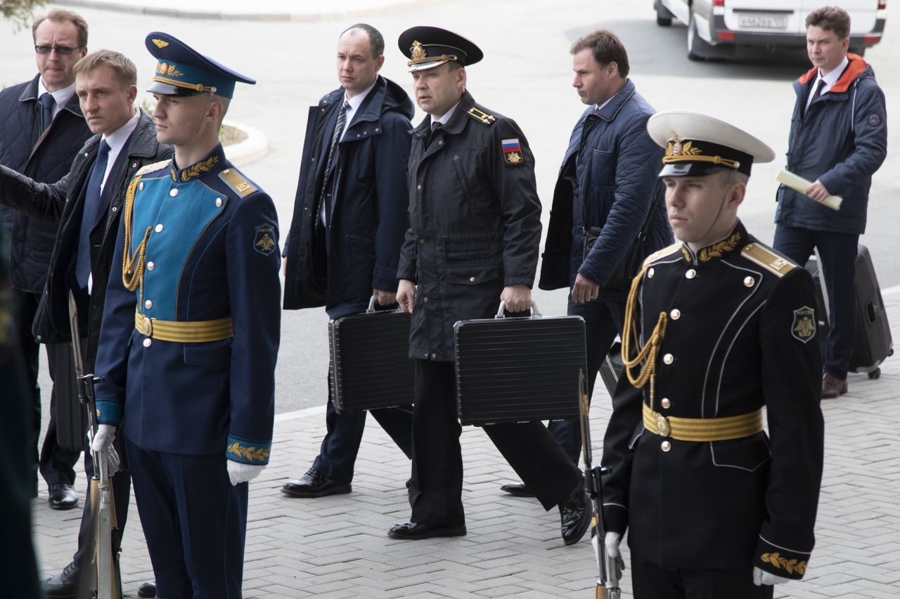Russian officers carry briefcases that appear to contain nuclear launch codes as Russian President Vladimir Putin arrives for talks with North Korea's leader Kim Jong Un in Vladivostok, Russia, Thursday, April 25.