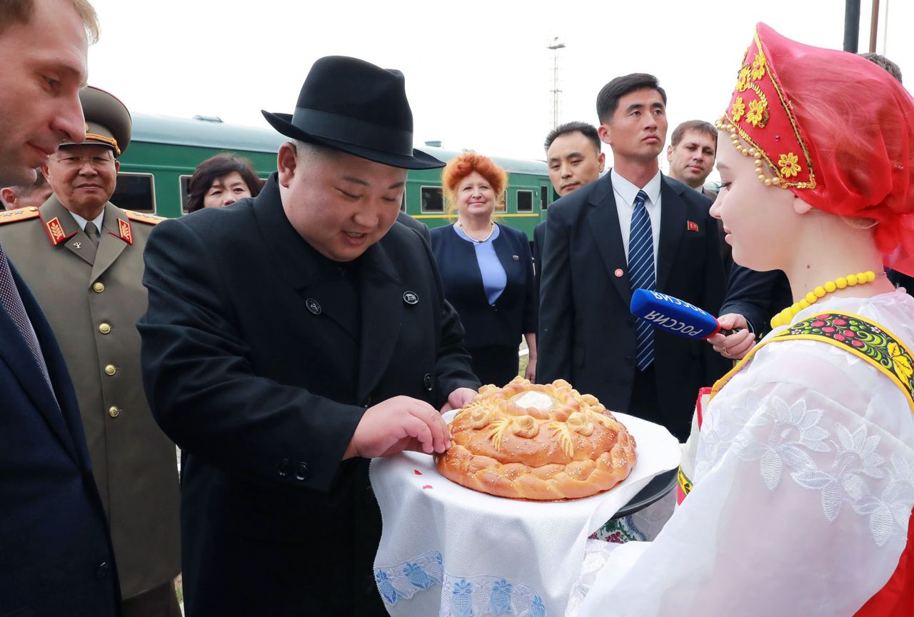 North Korean leader Kim Jong Un, center, receives bread and salt on his arrival at Khasan train station, Primorsky Krai region, Russia, on Wednesday, April 24. 