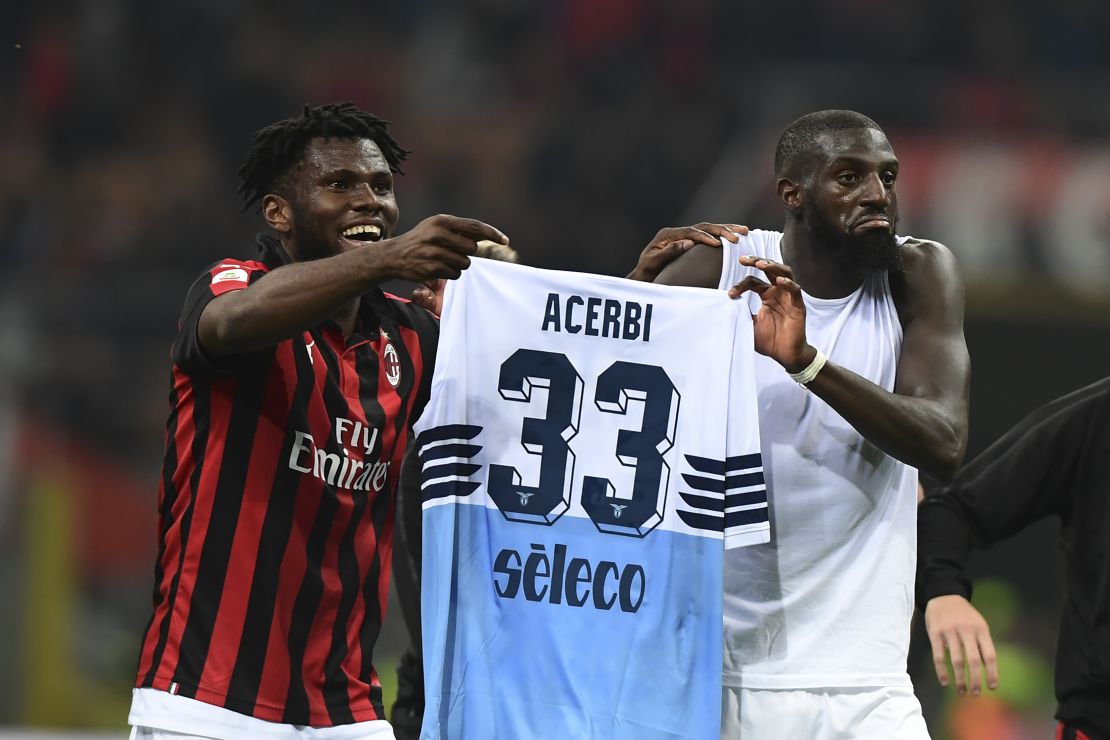 Franck Kessie (L) and Tiemoue Bakayoko hold the jersey of Lazio's Italian defender Francesco Acerbi after a Serie A league match.