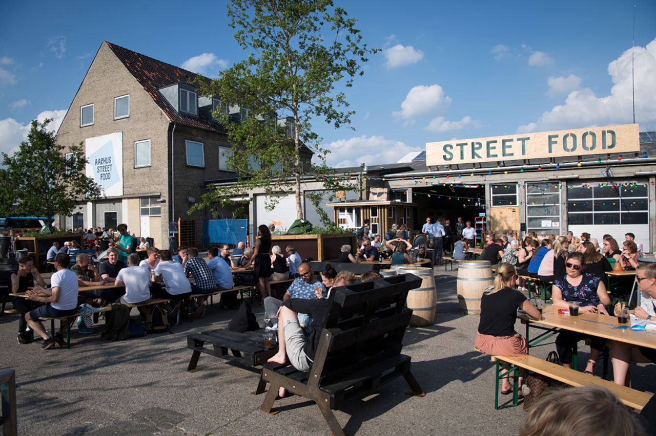 <strong>Aarhus Street Food:</strong> Come summer, this spot featuring a collection of 30 vendors is flooded with locals and tourists enjoying food and drink outdoors.