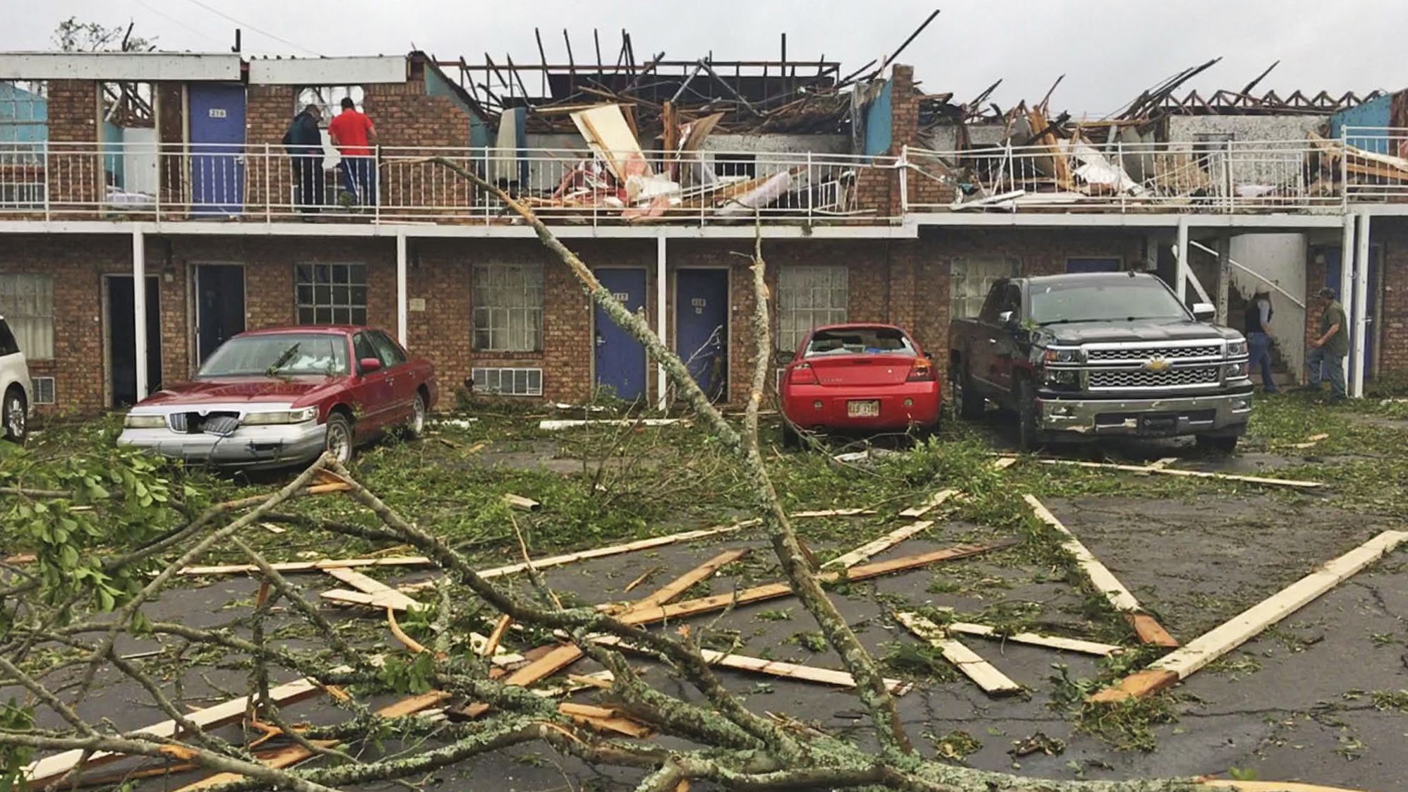 People survey damage at a motel that was slammed by a tornado Thursday in Ruston, Louisiana.