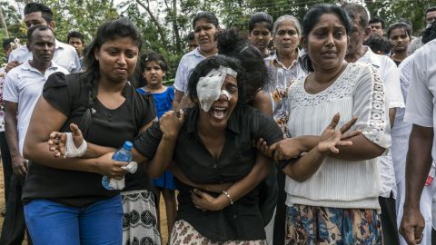 People grieve at a mass burial near St. Sebastian's Church in Negombo, Sri Lanka, on Wednesday, April 24. A wave of suicide bombings hit churches and hotels on Easter Sunday, <a href="https://www.cnn.com/2019/04/25/asia/sri-lanka-death-toll-lower/index.html" target="_blank">killing more than 250 people</a> across the country.