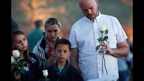 Will Beck, who escaped the Columbine High School shootings 20 years ago, joins his family at a memorial for the victims on Friday, April 19. Twelve students and one teacher were killed by a two students at the school on April 20, 1999. <a href="https://www.cnn.com/2013/09/18/us/columbine-high-school-shootings-fast-facts/index.html" target="_blank">The shooting</a> in Littleton, Colorado, is one of the worst mass shootings in US history.