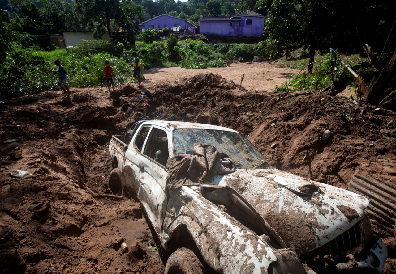 A wrecked vehicle remains after a body was recovered from under the mud following heavy rains in Mariannhill near Durban on Thursday, April 25. 