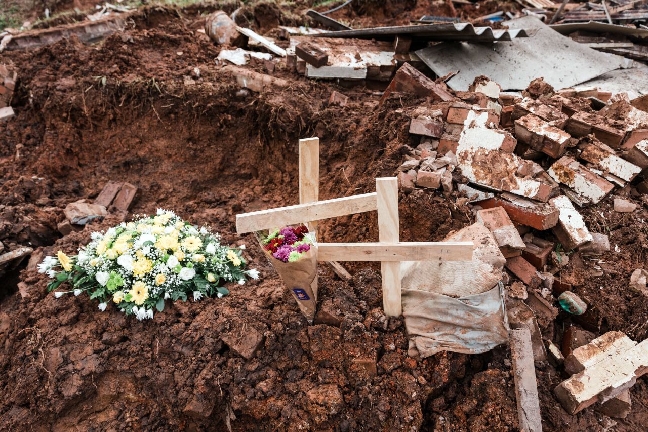 Flowers and crosses are placed on debris from a house destroyed by a mudslide in Chatsworth, south of Durban, on Wednesday, April 24. 