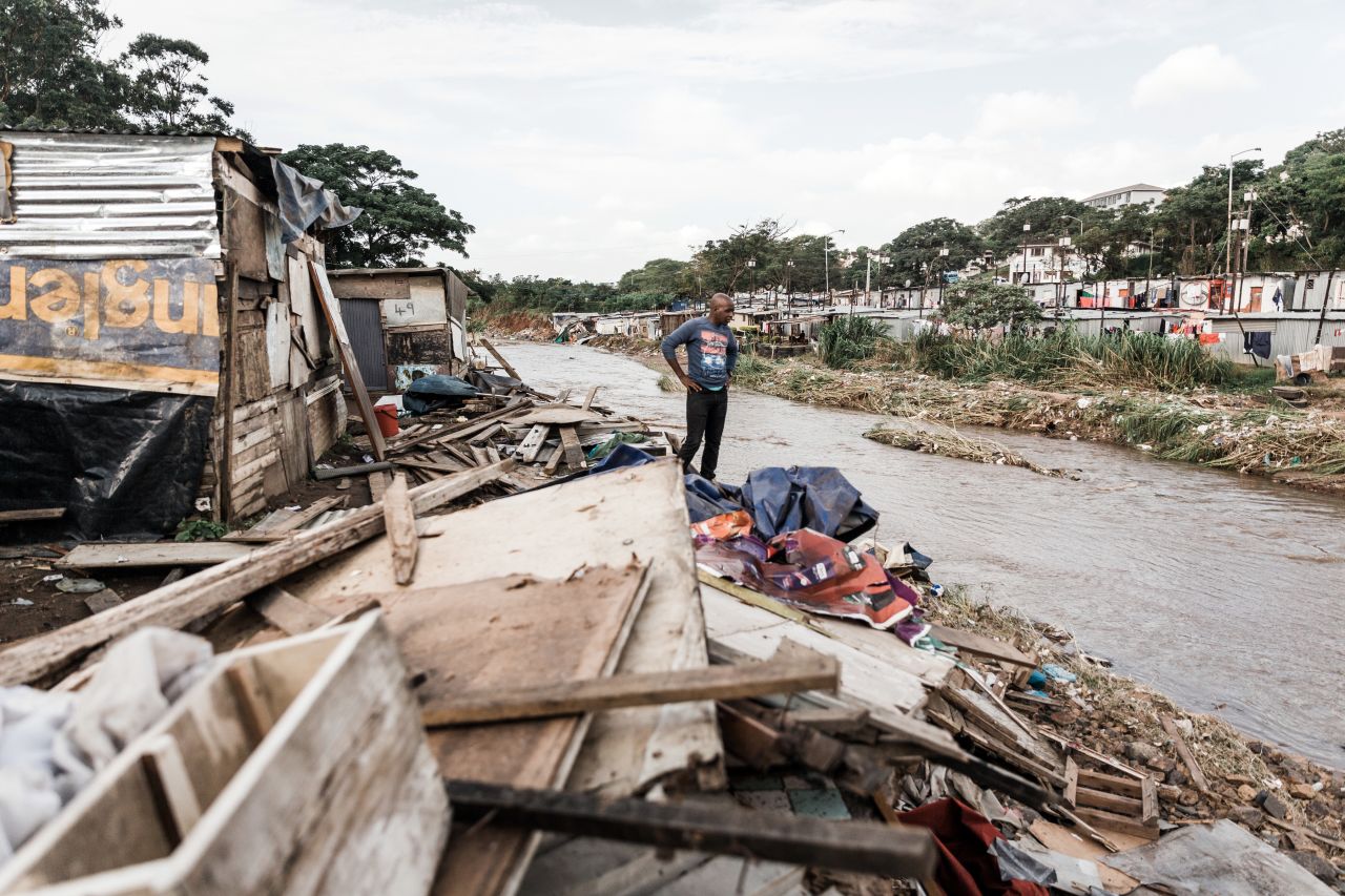A resident stands over debris in Durban on April 24.