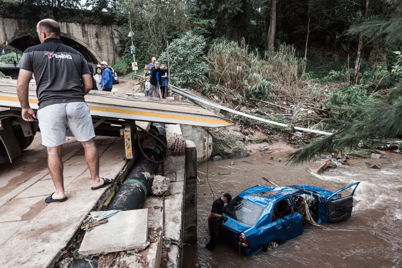 A tow truck company removes a car from a river after flash floods in Chatsworth on April 24.