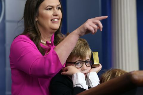 White House press secretary Sarah Sanders, standing next to her son Huck, calls on a child during a briefing at the White House on Thursday, April 25. Children of journalists and White House staff were invited to attend the briefing and ask her questions.