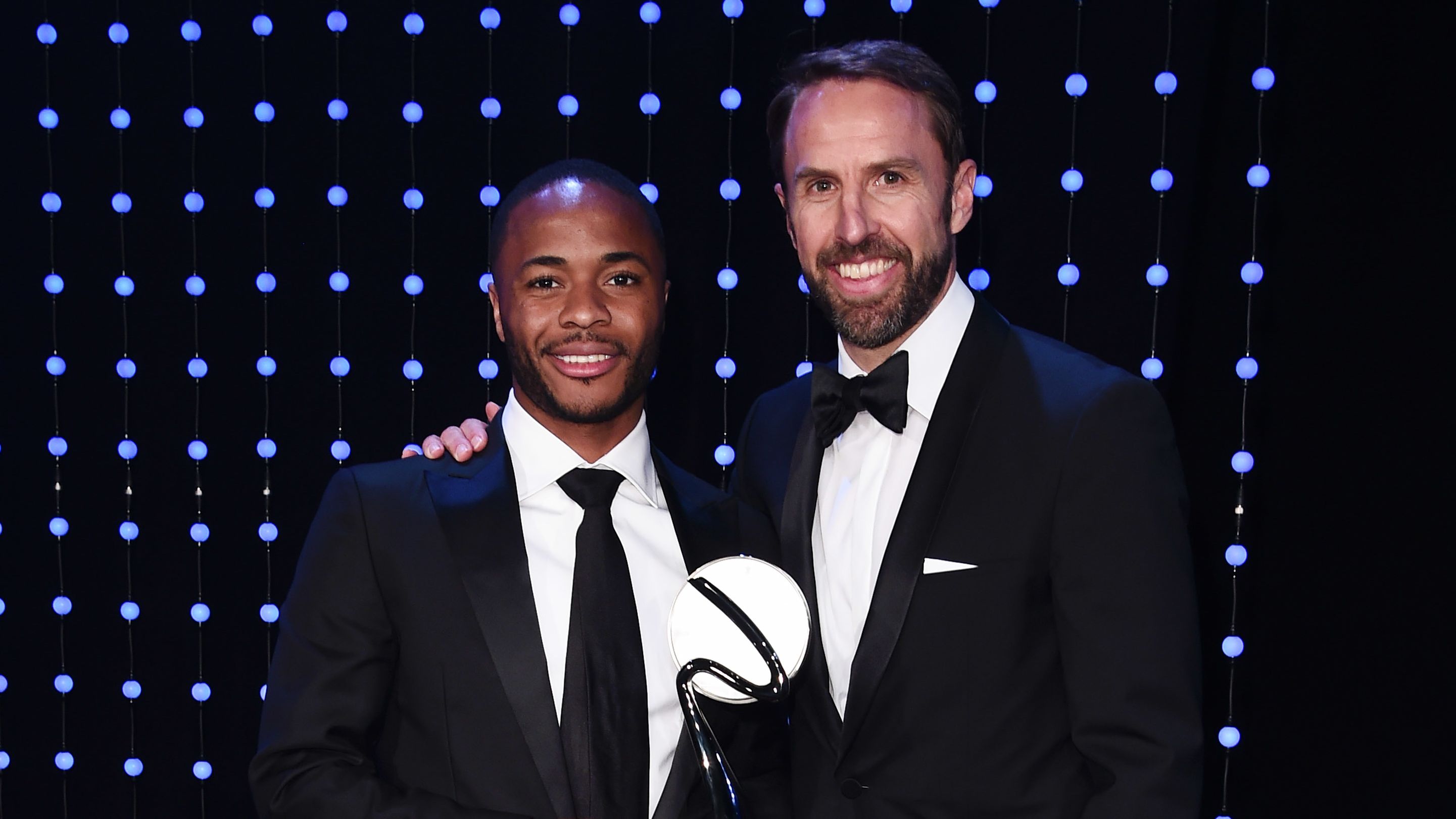 Raheem Sterling poses alongside England manager Gareth Southgate, who handed the winger his special award.