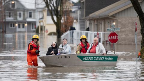 Firefighters evacuate residents of Sainte-Marie, Quebec, after the Chaudière River burst its banks.