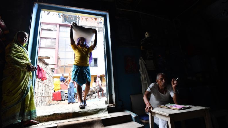 <strong>Guwahati:</strong> A worker carries a bag of food grains to a warehouse on April 30, 2018. Guwahati is the largest city in Assam state, which is in far eastern India. Its temples and nearby wildlife sanctuaries are starting to put it on tourists' radars.