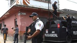 Municipal police stand guard on the corner of the street where the forensic office is located, where the bodies of Mixtla de Altamirano Mayor Maricela Vallejo, her husband and her driver were taken in Orizaba, Veracruz, Mexico, Thursday, April 25, 2019. Prosecutors said the three came under fire from behind and both sides of their SUV while traveling on a highway. (AP Photo/Felix Marquez)