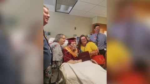 Family and friends gather around Johnson to celebrate his graduation.