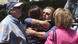 Members of the Chabad synagogue hug as they gather near the Altman Family Chabad Community Center, Saturday, April 27, 2019 in Poway, Calif. A shooting at a synagogue outside San Diego where worshippers were celebrating the last day of Passover sent multiple people to the hospital Saturday, but the extent of their injuries was not clear, officials said. (Hayne Palmour IV/The San Diego Union-Tribune via AP)