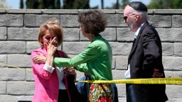 Synagogue members console one another outside of the Chabad of Poway Synagogue Saturday, April 27, 2019, in Poway, Calif. Several people were injured in a shooting at the synagogue. (AP Photo/Denis Poroy)