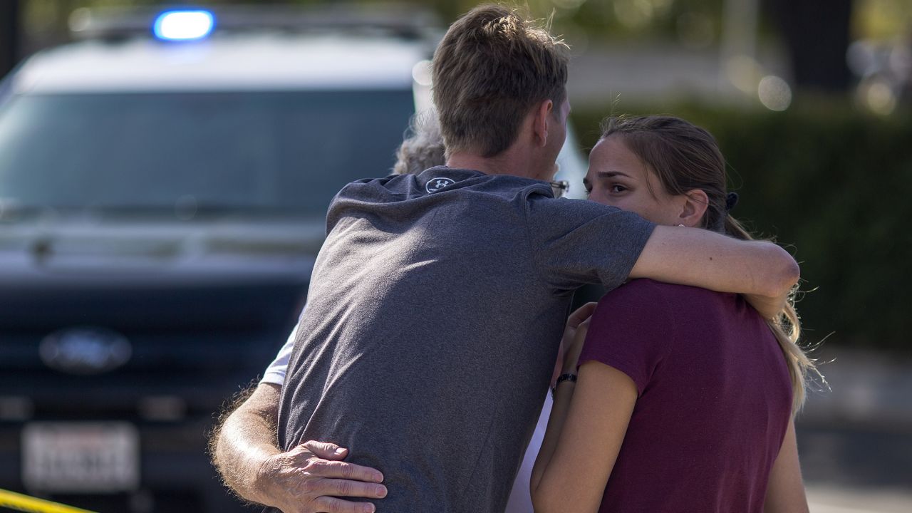 People embrace outside the Congregation Chabad synagogue.