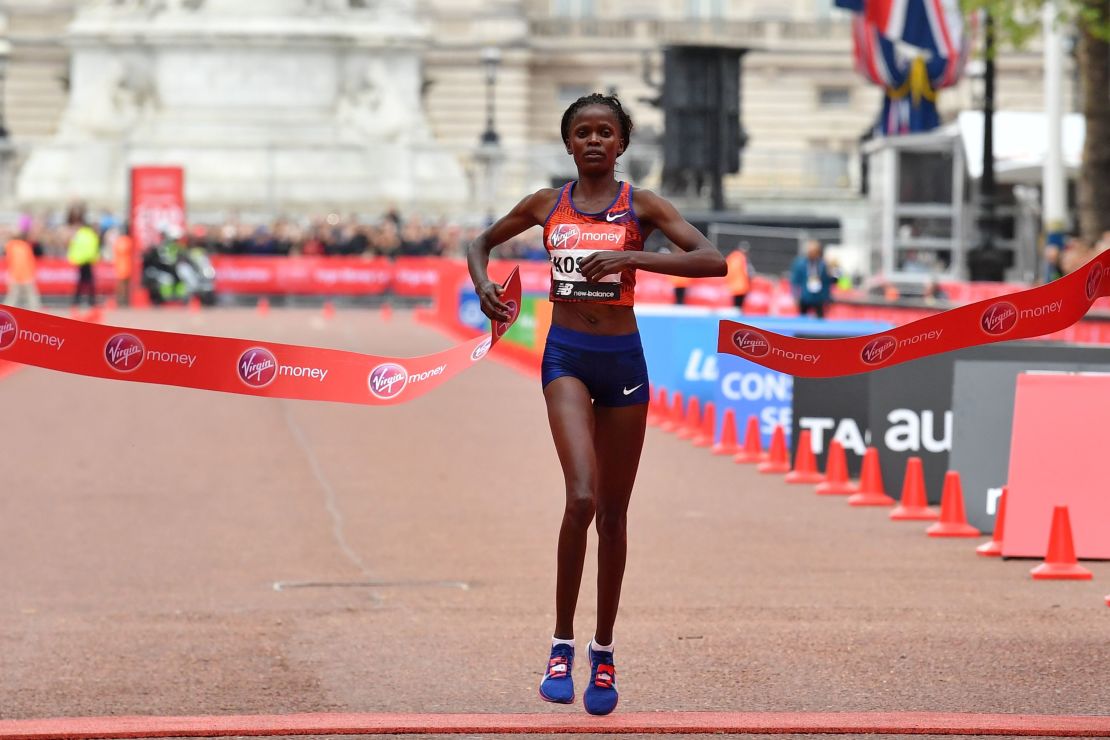 Kenya's Brigid Kosgei crosses the finish line to win the women's race.
