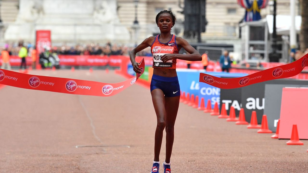 Kenya's Brigid Kosgei crosses the finish line to win the women's race.