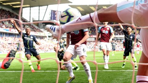 Burnley's Matthew Lowton fails to clear Sergio Aguero's shot in time.