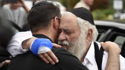 Rabbi Yisroel Goldstein, right, is hugged as he leaves a news conference at the Chabad of Poway synagogue, Sunday, April 28, 2019, in Poway, Calif. A man opened fire Saturday inside the synagogue near San Diego as worshippers celebrated the last day of a major Jewish holiday. (AP Photo/Denis Poroy)