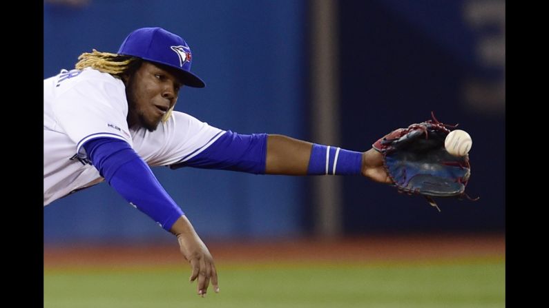 Toronto Blue Jays third baseman Vladimir Guerrero Jr. dives for a single by Oakland Athletics' Ramón Laureano during eighth-inning of a baseball game in Toronto on Friday, April 26.