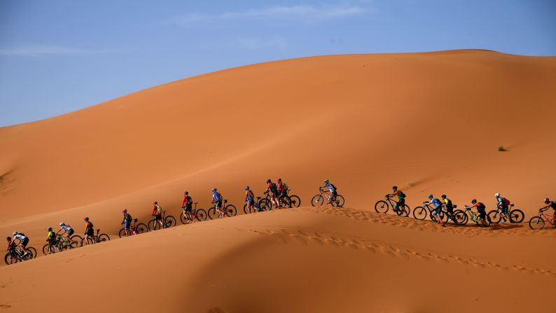 Competitors ride their bikes along sand dunes during the Stage One of the 14th edition of Titan Desert 2019 mountain biking race around Merzouga in Morocco on Sunday, April 28.